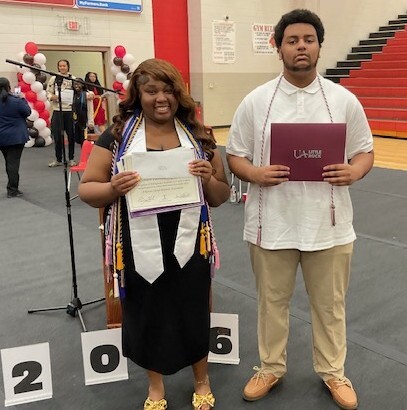 Nikira Henry and Eric Tooks winners of Camden Housing Authority Scholarships holding awards at ceremony.
